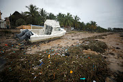 A washed up boat lies among storm debris on Wimbe beach as the region braces for further rainfall in the aftermath of Cyclone Kenneth, in Pemba, Mozambique, on April 27 2019.