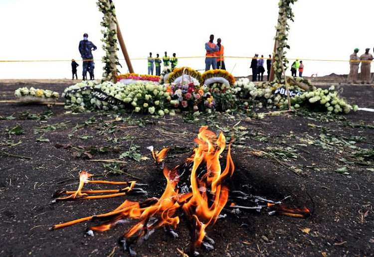 Candle flames burn during a commemoration ceremony for the victims at the scene of the Ethiopian Airlines Flight ET 302 plane crash, near the town Bishoftu, near Addis Ababa, Ethiopia March 14, 2019. REUTERS/Tiksa Negeri/File Photo