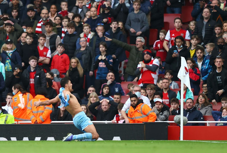 Rodri of Manchester City celebrates after scoring his side's second goal in the Premier League match against Arsenal at Emirates Stadium in London on January 1 2022.