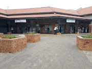 Sassa grant recipients standing one metre apart in a queue to enter Shoprite in Sophiatown.