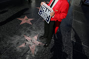 Greg Donovan, 58, stands on President Donald Trump's vandalised star on the Hollywood Walk of Fame in Hollywood, Los Angeles, California, in the United States on July 25 2018.  