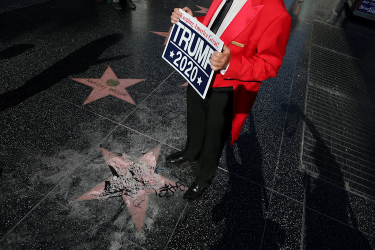 Greg Donovan, 58, stands on President Donald Trump's vandalised star on the Hollywood Walk of Fame in Hollywood, Los Angeles, California, in the United States on July 25 2018.