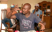 Bonakele Pakisi with his friends at his home yesterday after  SAPS members visited  his home to take a statement after a  Sunday paper reported that he confessed to lying to the court about the Coligny case. 