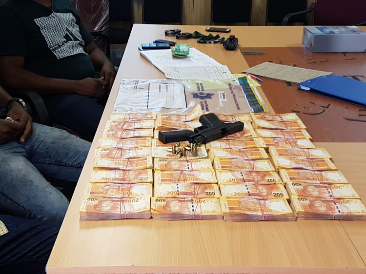 The money, firearm and ammunition recovered by police after being stolen from a house in Eshowe, KwaZulu-Natal.