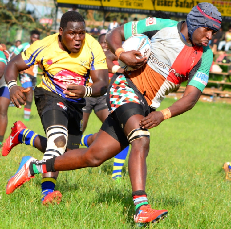 Harlequins' Wayne Mungei charges past Zedden Marrow of Homeboyz during their Kenya cup clash at RFUEA.