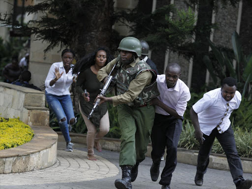 A security officer evacuateS survivors from the scene of DusIt terror attack on Tuesday /Monicah Mwangi