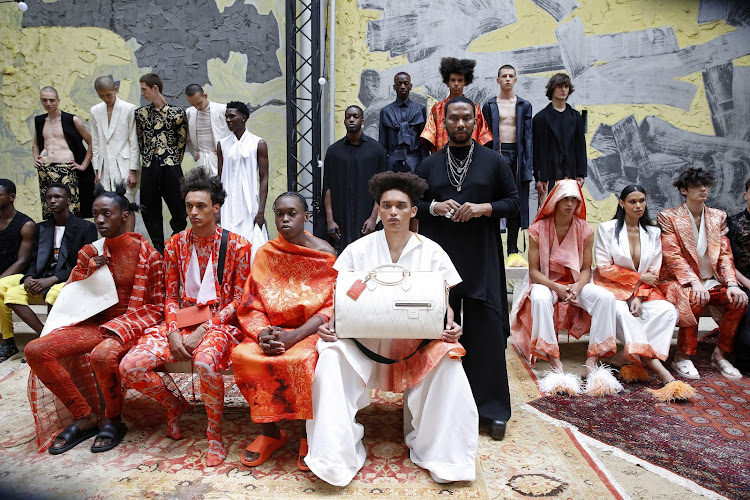 David Tlale poses with his models at his spring/summer 2023 presentation as part of Paris Fashion Week.