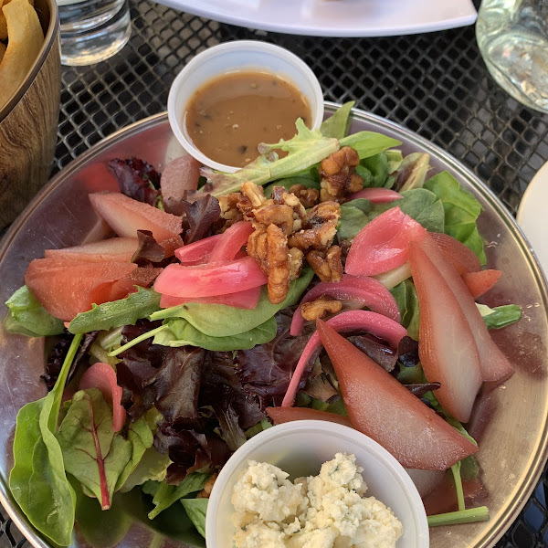 Pear salad witb dressing and blue cheese on the side