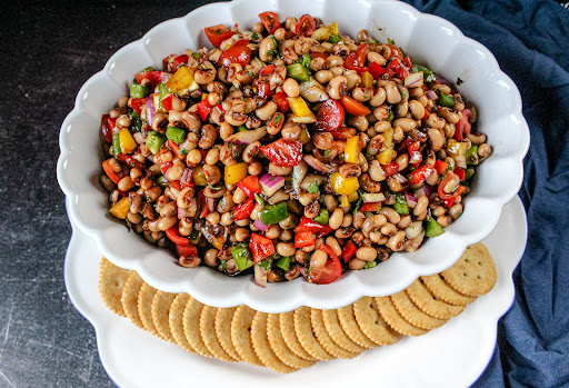 A bowl of Black-Eyed Peas Dip with crackers.