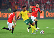 Bongani Zungu seen here challenged by Tarek Hamed (R) and Abdallah Said (L) of Egypt is back in the squad to face Sao Tome e Principe.