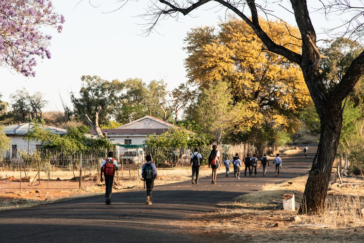 Children walk across town to Pomfret’s only school early on an October morning.