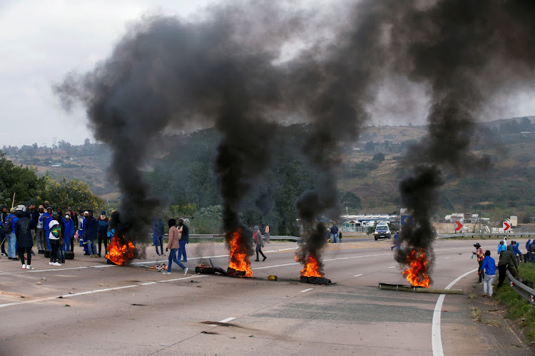 FILE PHOTO: Supporters of former South African President Jacob Zuma block the freeway with burning tyres during a protest in Peacevale, South Africa, July 9, 2021.