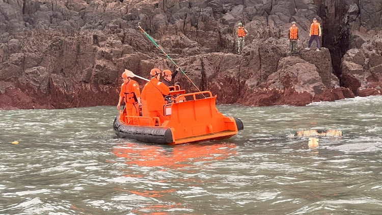 Members of Taiwan's coast guard work during a rescue operation after a Chinese fishing boat capsized near Taiwan-controlled Kinmen islands, off the coast of Dongding Island, Kinmen County, Taiwan, in this handout image released on March 14, 2024.