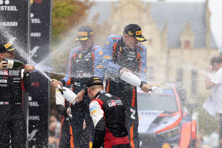 Ott Tanak (left) and Martin Jarveoja celebrate on the final podium in Ypres during Day Four of the FIA World Rally Championship Belgium on August 20, 2022 in Ypres, Belgium.