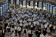 Commuters wearing face masks arrive at Shinagawa Station at the start of the working day amid the coronavirus disease (Covid-19) outbreak, in Tokyo, Japan, August 2, 2021 .