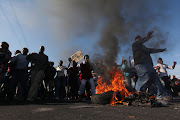 People protest on the N2 highway. File photo