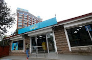 An employee of Telkom Kenya stands outside the company's shop near the company's headquarters in Nairobi, Kenya. File photo 