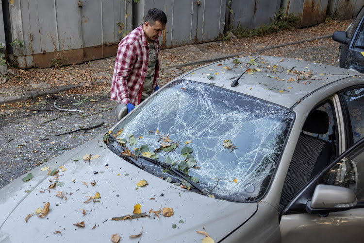 A resident inspects the damage to his car after a Russian missile strike in Kyiv, Ukraine, September 21 2023. Picture: ALINA SMUTKO/REUTERS