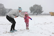 Jenna Axsel plays with Onalenna Monama, at Jackson Dam in Alberton, South of Johannesburg.   