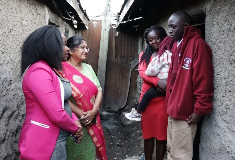 Well-wishers Nancy Ndegwa and Divia Shah with Lucy Wangeci and her son Antony Kinyua / KNA