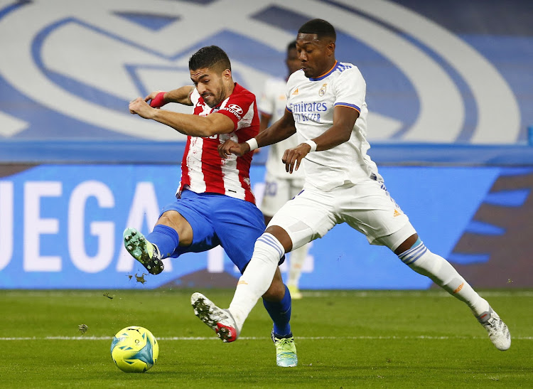 Real Madrid's David Alaba in action with Atletico Madrid's Luis Suarez