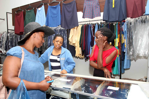 IMPORTANT PURCHASE: Kei uniform staff Pretty Mpapa and Ntombikayise Gxakaza help a customer out Picture: S1BONGILE NGALWA