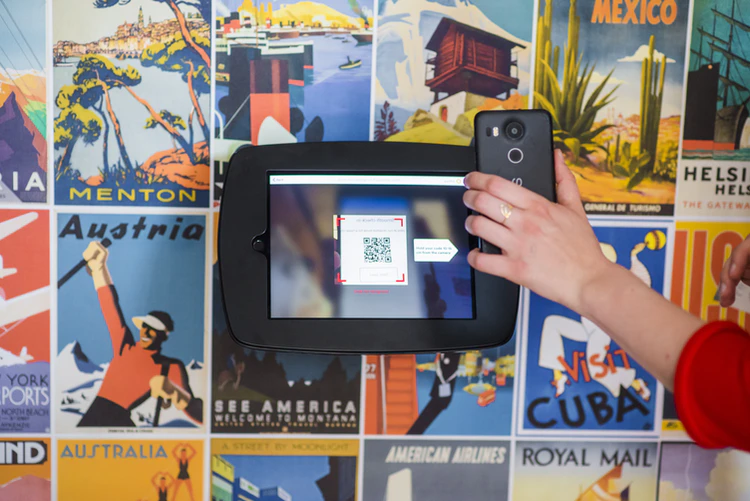 Customer scanning a code from his mobile to check-in and enter the fitness centre