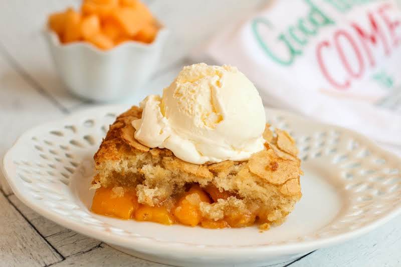 A Slice Of Cantaloupe Peach Cobbler With Ice Cream.