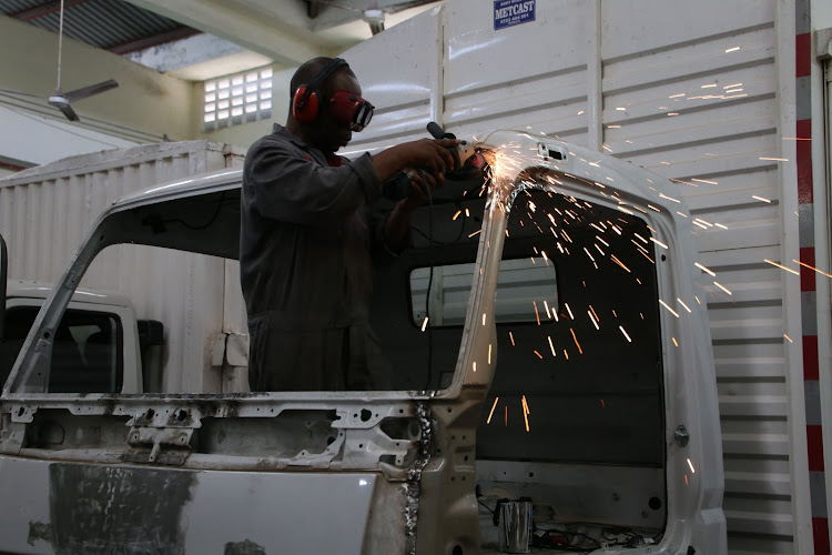 A Simba Colt Motors mechanic at work at their premises in Sparki, Mombasa on Thursday.