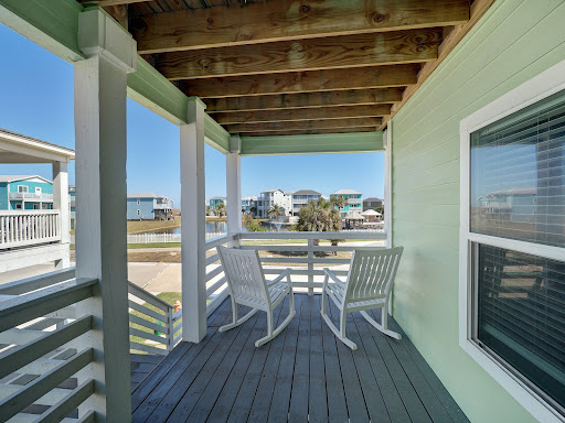 Balcony with rocking chairs and view of houses - Luxury house for sale in Port Aransas, 4 bedrooms