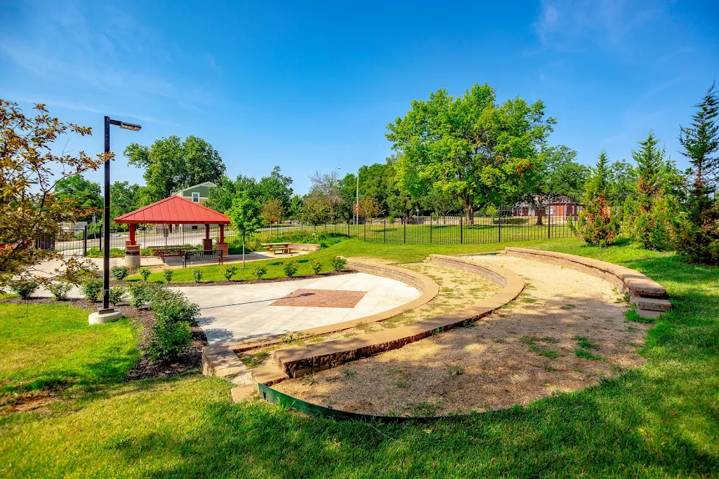 Outdoor gathering area with shade trees and covered picnic area 