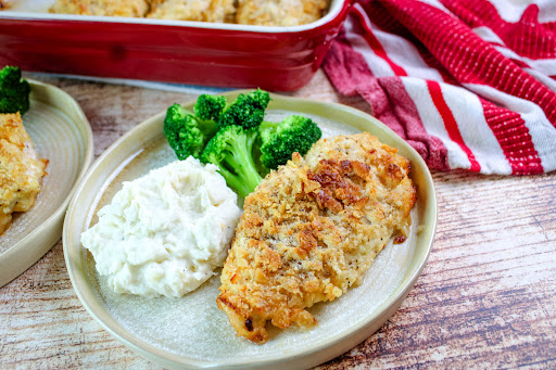 Crispy Cracker Butter Chicken on a plate with mashed potatoes and broccoli.