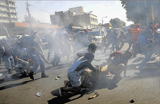 CAMPUS CHAOS: Wits students scatter after police fired a stun grenade