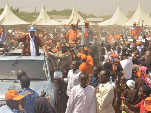 Garissa Governor Nathif Jama, Mbalambala MP Abdulkadir Aden and ODM leader Raila Odinga wave from their vehicles at a rally in Garisa town yesterday/EMMANUEL WANSON