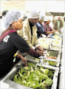 HARD AT WORK: Thobile Motha and Mpumalanga premier David Mabuza prepare food at Piet Retief Hospital as part of Mandela Day celebrations. Pic: ANDREW HLONGWANE. 19/07/2009. © Sowetan.