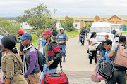 EVACUATION: WSU students from BCM’s Potsdam site are escorted out of their residences by heavily armed police officers.