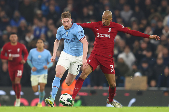 Liverpool midfielder Fabinho competes for the ball with Kevin de Bruyne of Manchester City during their Carabao Cup 4th round match at Etihad Stadium on December 22 2022 in Manchester, England.