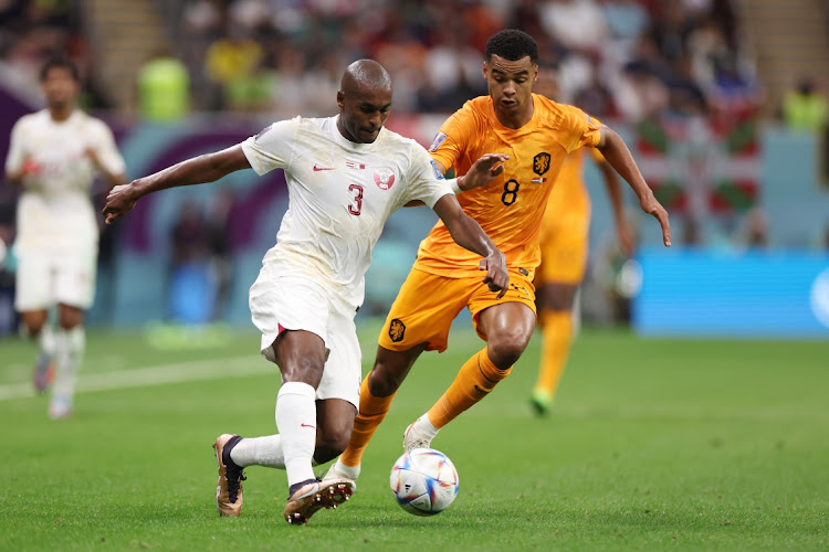 Abdelkarim Hassan of Qatar is challenged by Cody Gakpo of Netherlands during the Fifa World Cup 2022 Group A match between Netherlands and Qatar at Al Bayt Stadium in Al Khor, Qatar, November 29 2022. Picture: CATHERINE IVILL/GETTY IMAGES