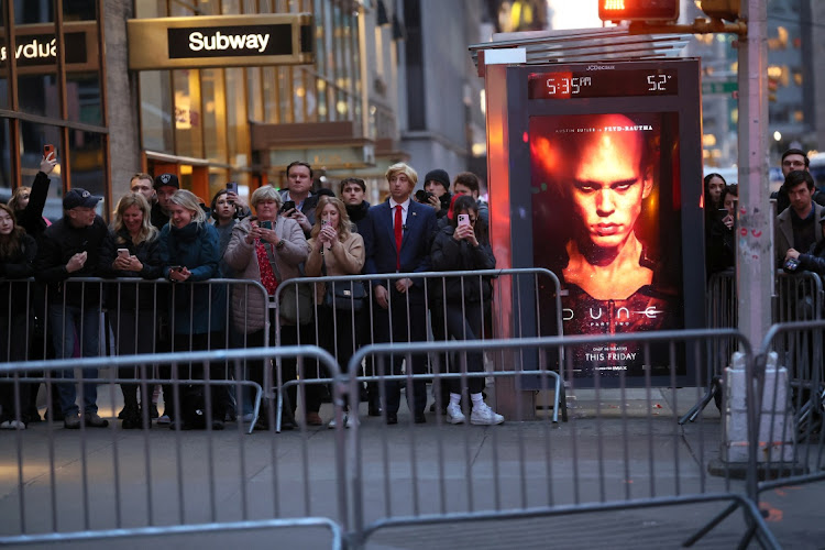 Onlookers wait at barricades near NBC studios as US President Joe Biden visits Late Night with Seth Meyers in downtown New York, NY, US February 26, 2024.