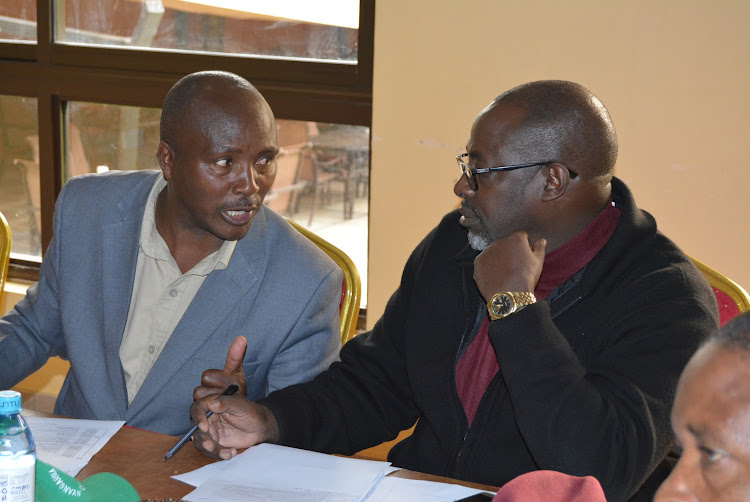 Nyandarua assembly Budget committee chairman Kiiru Gachomba and his Education counterpart Sambigi Mukuria scrutinising 2019-20 budget estimates on Tuesday.