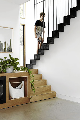 Perforated steel on the upper flight of stairs is a lovely textural contrast to the plywood on the lower stairs.