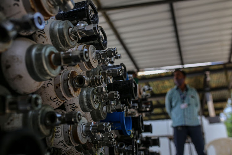 Empty oxygen cylinders are stacked in a facility at Naidu Hospital in Pune, Maharashtra, India, May 6 2021. Picture: DHIRAJ SINGH/BLOOMBERG