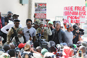 Operation Dudula leader Nhlanhla 'Lux' Dlamini, aka Ntlantla Mohlauli, addresses supporters outside the Roodepoort magistrate's court on March 28 2022. The writer says no country can afford to accommodate all immigrants, documented and undocumented