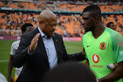 Kaizer Chiefs football manager Bobby Motaung congratulates goalkeeper Daniel Akpeyi after a match. 