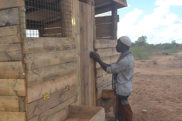 Mohamed Guyo Ware, a pastoralist from Bula Salama in Hola Tana River county, at his new livestock new shelter which will now save his animals from being killed by hyenas