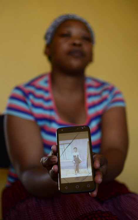 Lerato Khukhwane holding her cell-phone projecting Lesego Khukhwane an 18 years old girl who lost her life at Mmabatho Stadium over the weekend during Mahika-Mahikeng music and cultural festival.