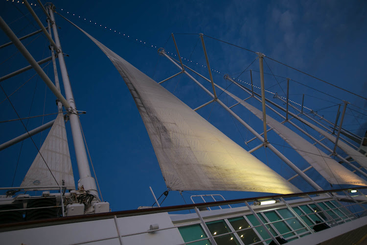 The sails at twilight on Wind Surf, flagship of Windstar Cruises. 