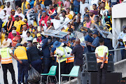 Police protect Kaizer Chiefs coach Arthur Zwane from fans throwing bottles during the DStv Premiership match between SuperSport United and Kaizer Chiefs at Royal Bafokeng Stadium on May 13, 2023 in Rustenburg, South Africa.   