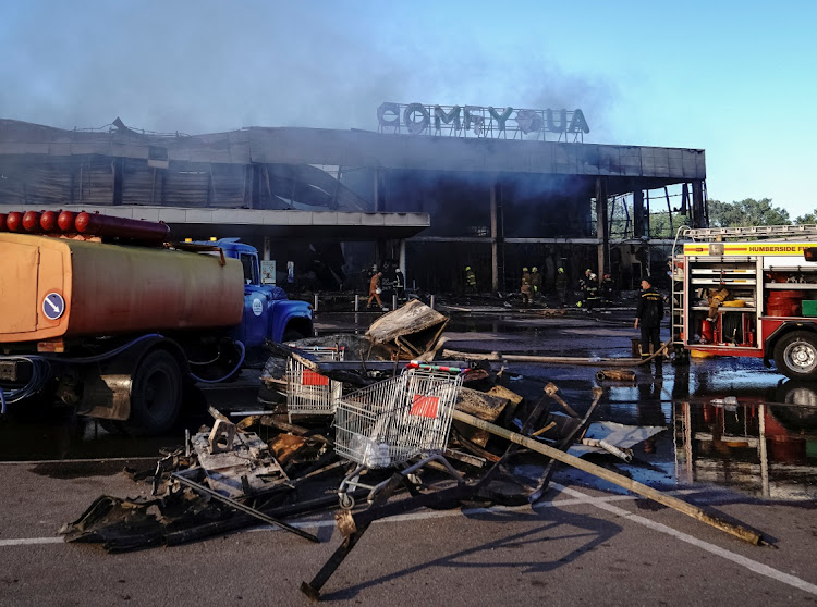 Rescuers work at a site of a shopping mall hit by a Russian missile strike, as Russia’s attack on Ukraine continues, in Kremenchuk, in Poltava region, Ukraine, on June 27 2022. Picture: REUTERS/ANNA VOITENKO