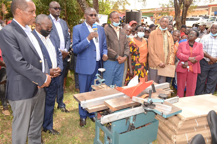 Trade Principal Secretary Johnson Weru hands over equipment to Gatanga Constituency Industrial Development Centre on Monday.